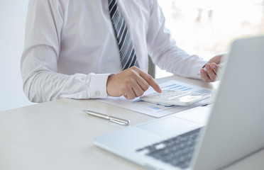 Fototapeta premium Business men are calculating real estate investment expenditures and analyzing the company's finances in line with the global economy, Analysis of financial accounting concept.