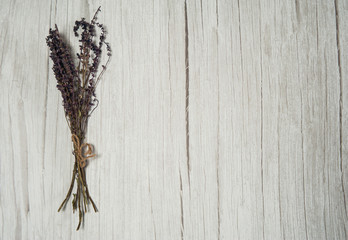 Phytotherapy. Composition of dry herbs for herbal medicine. A bunch of dry sage grass (Salvia officinalis) on a light wooden background. Free space.