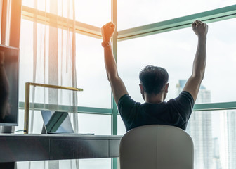 Business achievement concept with happy businessman relaxing in office or hotel room, resting and...
