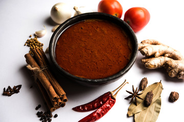 North Indian basic spicy Curry or masala for vegetables or chicken or mutton recipe shown with ingredients, served in a bowl. selective focus	homemade, restaurant, hot, oil, dark, red, indian, india, 