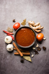 Obraz na płótnie Canvas North Indian basic spicy Curry or masala for vegetables or chicken or mutton recipe shown with ingredients, served in a bowl. selective focus homemade, restaurant, hot, oil, dark, red, indian, india, 
