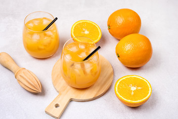 Tasty and Refreshing Orange Juice in Glass with Black Straws on Light Gray Background Fresh Ripe Oranges Horizontal