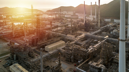 Aerial view oil and gas tank with oil refinery background at night, Business petrochemical industrial, Refinery factory oil storage tank and pipeline,  Ecosystem and healthy environment concepts.