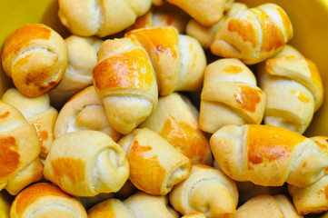 Process of making croissant rolls. Making domestic croissant rolls and using brush to add egg topping on rolls. French pastry goods