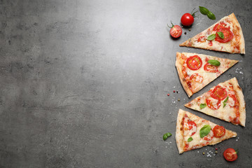 Slices of delicious pizza Margherita on grey table, flat lay. Space for text