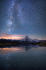 Matterhorn peak at night with many stars in sky. Scenic landscape. Switzerland.