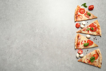 Obraz na płótnie Canvas Slices of delicious pizza Margherita on light grey table, flat lay. Space for text