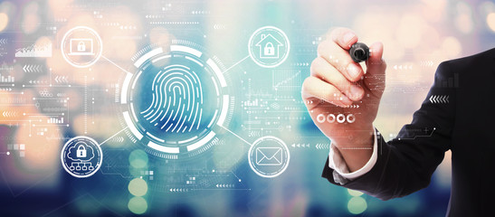 Fingerprint scanning theme with businessman on blurred abstract background