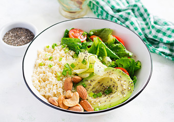 Trendy salad. Vegan Buddha bowl with bulgur, avocado, cucumber, lettuce, tomatoes and chia seeds. International Day Without Meat. Vegetarian salad.