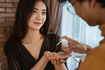 people sharing hand sanitizer to prevent infection of a virus, germ and bacteria