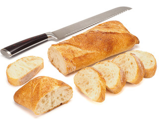 French baguette cut in pieces and knife isolated on a white background