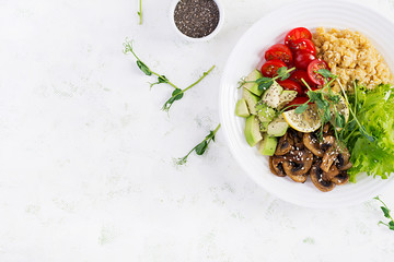 Trendy salad. Vegan Buddha bowl with lentil, avocado, mushrooms, lettuce, tomatoes and chia seeds. International Day Without Meat. Vegetarian salad. Top view, overhead, flat lay
