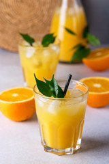 Tasty and Refreshing Orange Juice in Glass with Black Straws on Light Gray Background Fresh Ripe Oranges