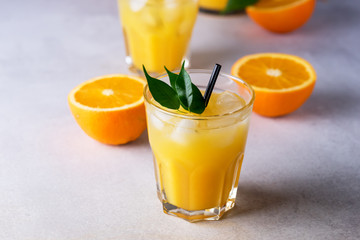 Tasty and Refreshing Orange Juice in Glass with Black Straws on Light Gray Background Fresh Ripe Oranges