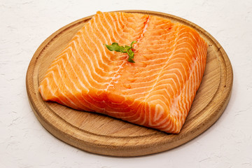 Fresh salmon filet. Wooden cutting board