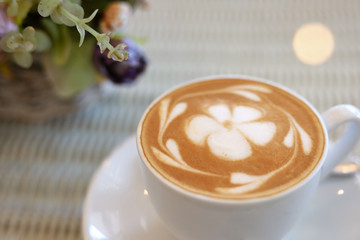 frangipani plumeria fragrant flower of latte art in hot coffee drink put on table in cafe restaurant