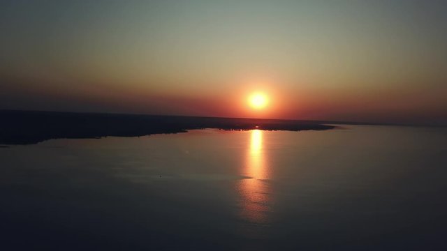 aerial view of sunset over sea, Beautiful sunrise Ocean, evening wawes on the sea, Beautiful reflections on water surface at sunset
