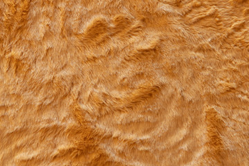 Brown real wool with a dark top texture background, orange natural wool,  fluffy fur texture for designers, close-up  wool rug