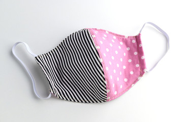 black and pink design of face mask handmade from fashion fabric cloth isolated on white background