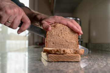 healthy eating, fresh bread, homemade, hands, knife, home interior, kitchen, kitchen interior, concept, closeup, close up, man, cook, natural, organic, healthy, rich and tasty