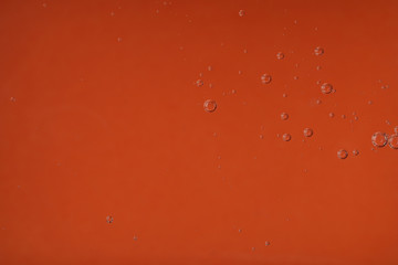 Pure transparent cosmetic gel on orange background, closeup