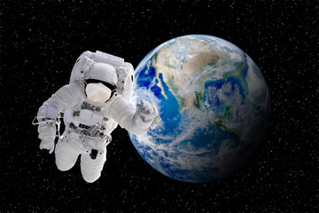 Fototapeta na wymiar CORONA Virus in Healthcare Concept : Astronaut floating in space and wear protective masks to protect CORONA virus with blue planet earth in background. (Elements of this image furnished by NASA)