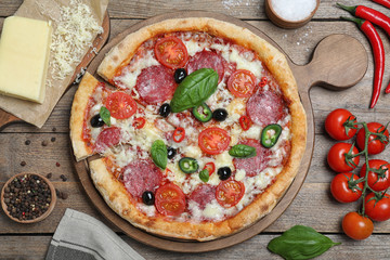 Delicious pizza Diablo on wooden table, flat lay