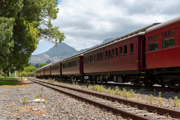 Fototapeta na wymiar Elgin, Western Cape, South Africa. Dec 2019. Elgin station in the Overberg region of the Western Cape. Vintage tourist train at Elgin Station