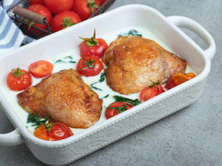 baked chicken thigh with creamy spinach and cherry tomatoes