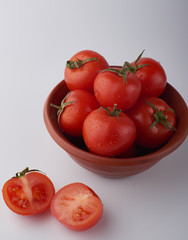 Close-up of fresh ripe tomatoes on a wooden and white background