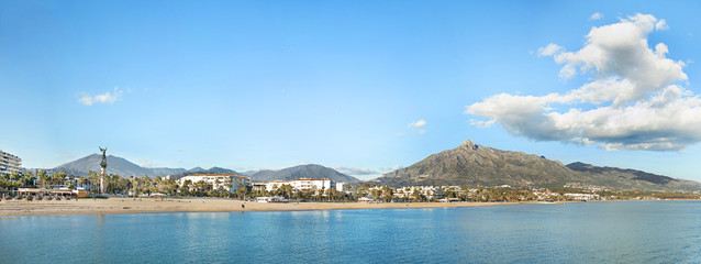 Fototapeta na wymiar Panoramic view of Bay Banus Beach , in luxury location near Banus Bay, Marbella. The statue 