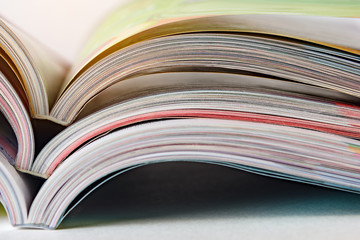 Colorful pages of an open magazine, close up. Selective focus.