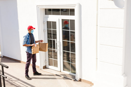 Delivery Guy In Protective Mask Near The Customer House, Outdoors