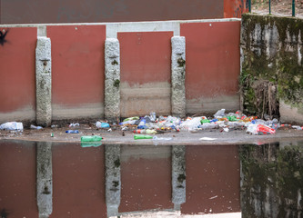plastic and other polluting waste abandoned in the bed of a river