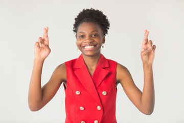 beautiful young african woman on white background in red suit with hand gesture