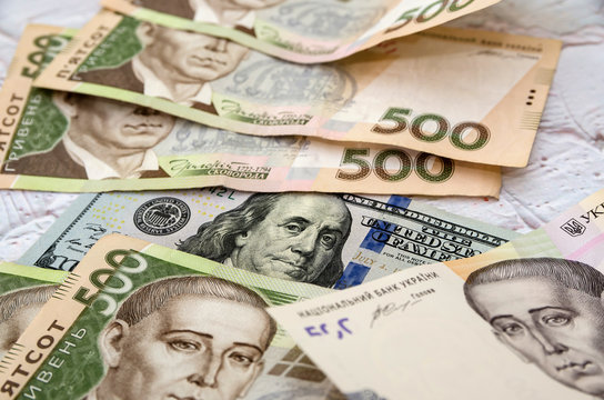 Ukrainian money - hryvnia banknotes USA dollars bills. Finance in Ukraine, of the hryvnia to the dollar exchange rate. Multi currency money dollars and hryvnia, close-up concept finance investment.