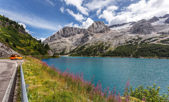 Wonderful Summer landscape. Fedaia lake with Marmolada peaks covered by ice, Dolomites, Italy. Amazing nature landscape. Picture of wild area
