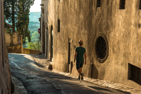 a man strolling alone in a narrow country road on the hills of florence (arcetri, pian dei giullari)