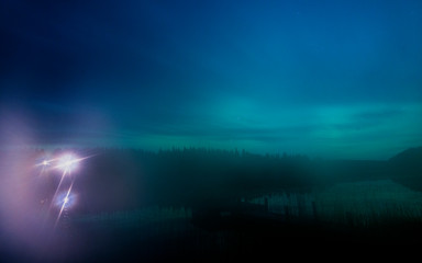 Fototapeta na wymiar Fog during dusk reflected over the lake, Sweden, Norrbotten