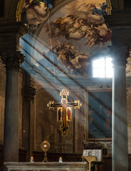 the badia fiorentina with its presbitery and the holy cross enlighted by sunbeams