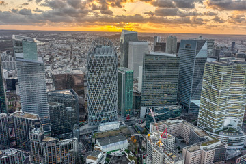 Aerial drone shot of La Defense business district skyscrapers during sunset