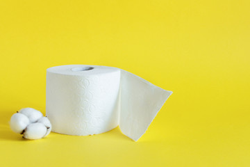 Rolls of toilet paper on yellow color background.