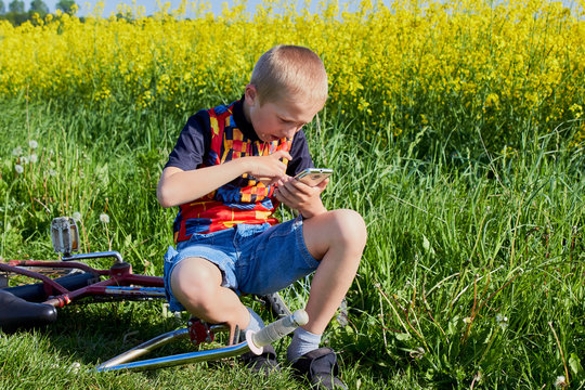 boy on smartphone reads news on nature,boy in nature flips through the COVID-19 epidemic and disease news website