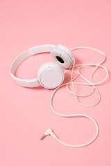 Music: White headphone on a pink background.