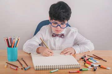child drawing on a table