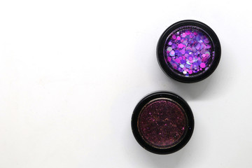 Two circular boxes of glitter for make up