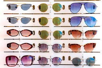 Stand with many sunglasses in a store of optics