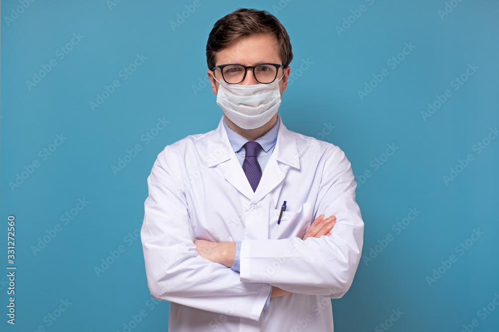 Wall mural Physician or doctor posing with a face mask