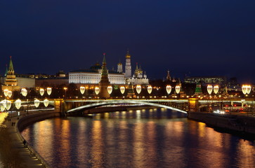Night view of the Moscow Kremlin, the Big Stone bridge with festive illumination and the Prechistenskaya embankment. Moscow, Russia