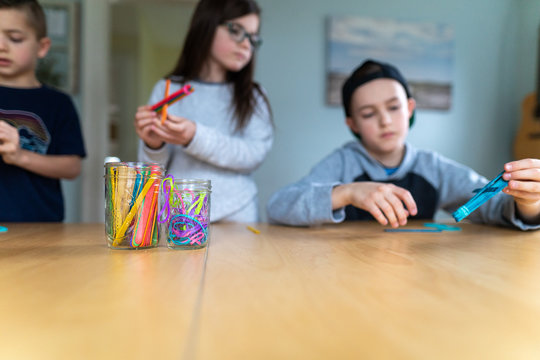 Children building catapults with popsicle sticks and rubberbands as part of a homeschool stem lesson